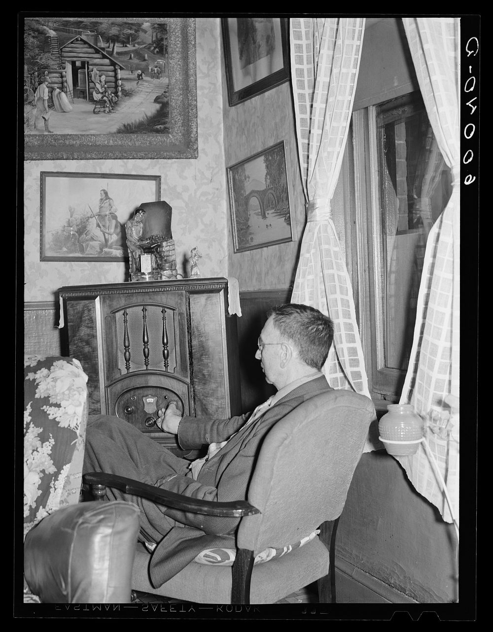 Man listening to radio in hotel lobby. Del Monte Hotel, Elkins, West Virginia. Sourced from the Library of Congress.