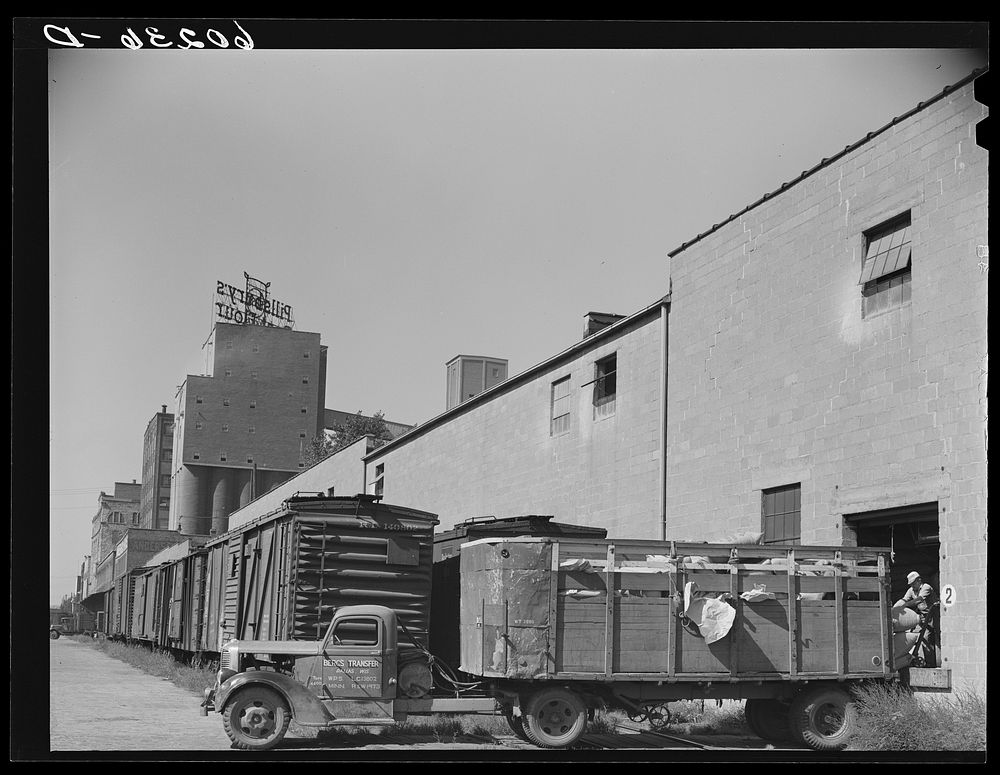 Truck loading up with cattle feed at Pillsbury flour mill. Minneapolis, Minnesota. Sourced from the Library of Congress.