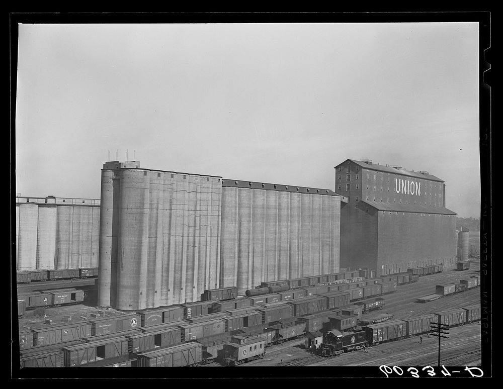 Grain elevators with freight cars unloading. Minneapolis, Minnesota. Sourced from the Library of Congress.