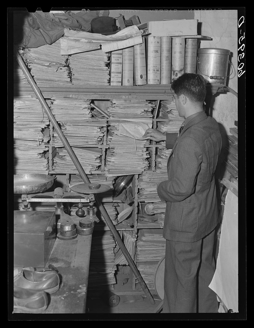 Editor of the Litchfield Independent going through back files of the paper. Litchfield, Minnesota. Sourced from the Library…