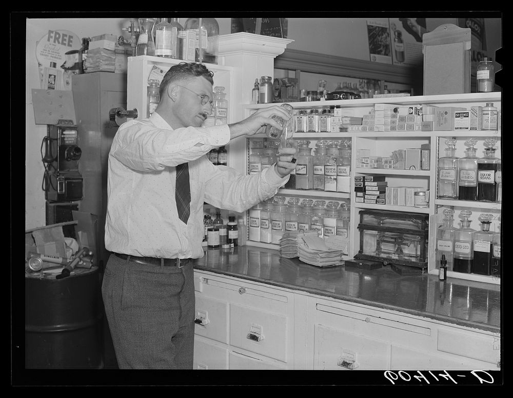 Pharmacist filling prescription. Graceville, Minnesota. Sourced from the Library of Congress.