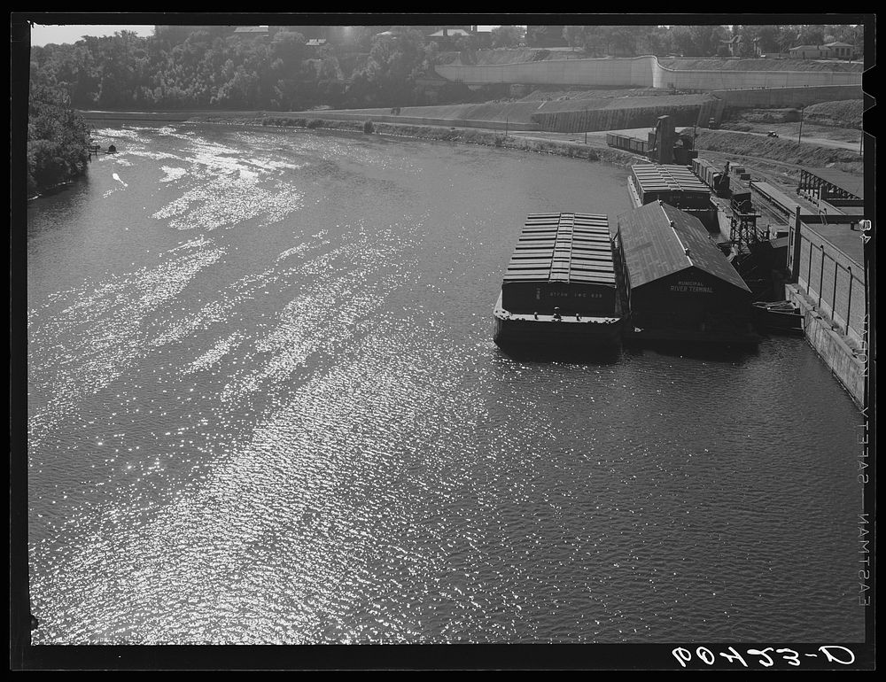 Barges on the river. Minneapolis, Minnesota. The one in the foreground is loaded with wheat for Memphis. Sourced from the…