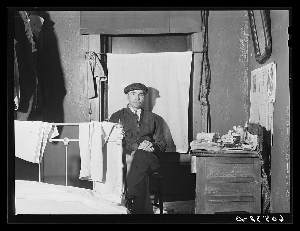 Transient farm laborer in hotel room which he rents for one dollar and fifty cents a week. Dubuque, Iowa. Sourced from the…