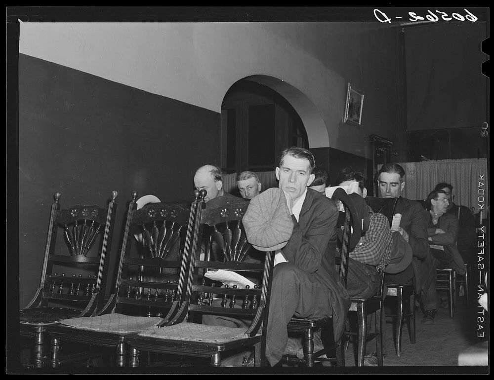 Transient men listening to sermon during evening service at city mission,  Dubuque, Iowa. After the services they fumigate…