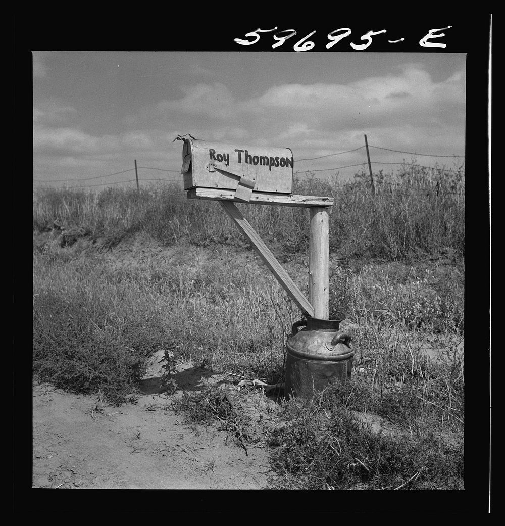Mailbox supported by old milk can, on farm near Lexington, Nebraska. Sourced from the Library of Congress.