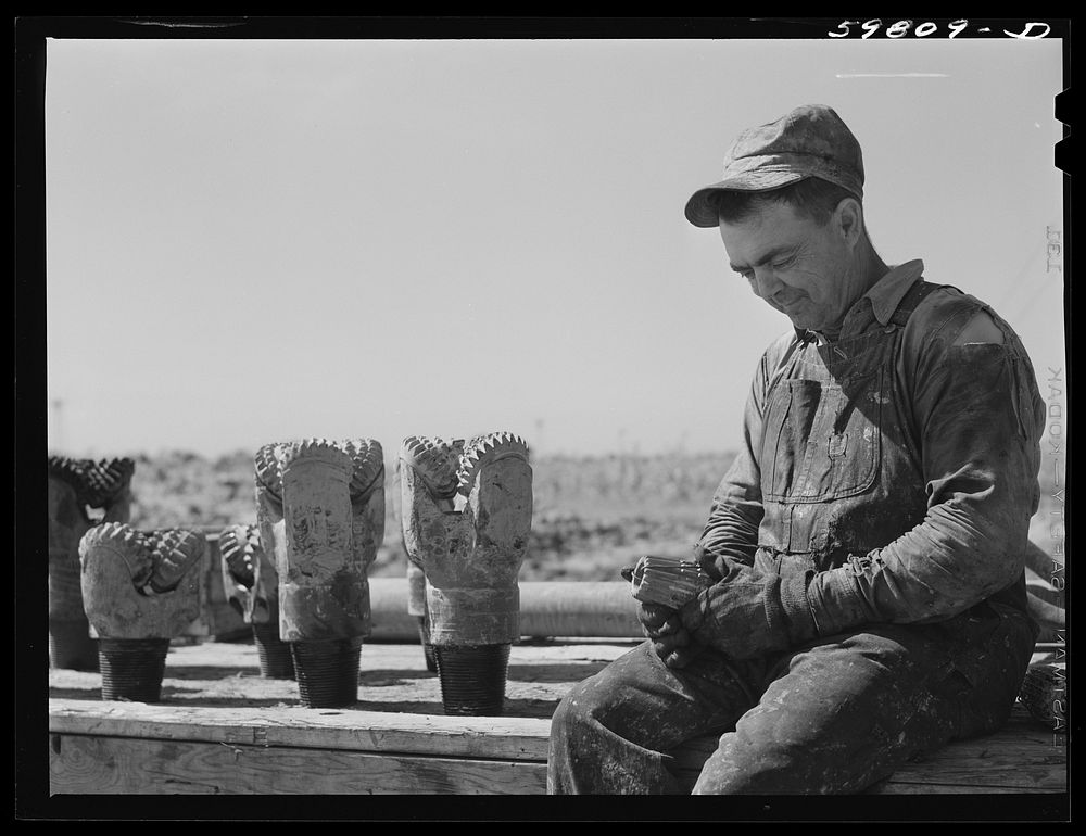 [Untitled photo, possibly related to: Jim Eckles, water pumper, "backup man," with drill bits used in oil well in C.C.…