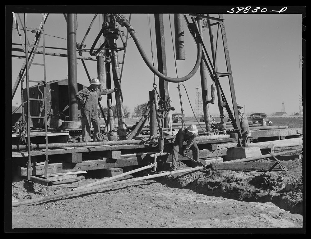 Preparing to drill an oil well in Goodrich field of Continental oil company. Valley Center oil field near Wichita, Kansas.…