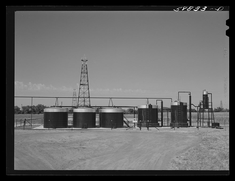 Oil well derricks and oil tanks in Moundridge area near McPherson, Kansas. Sourced from the Library of Congress.