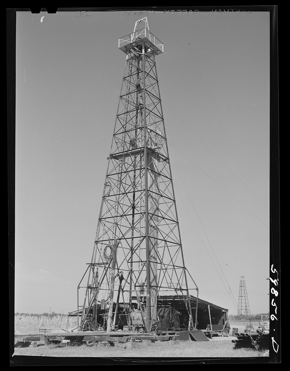 [Untitled photo, possibly related to: Oil well derricks and pumps in Moundridge area near McPherson, Kansas]. Sourced from…