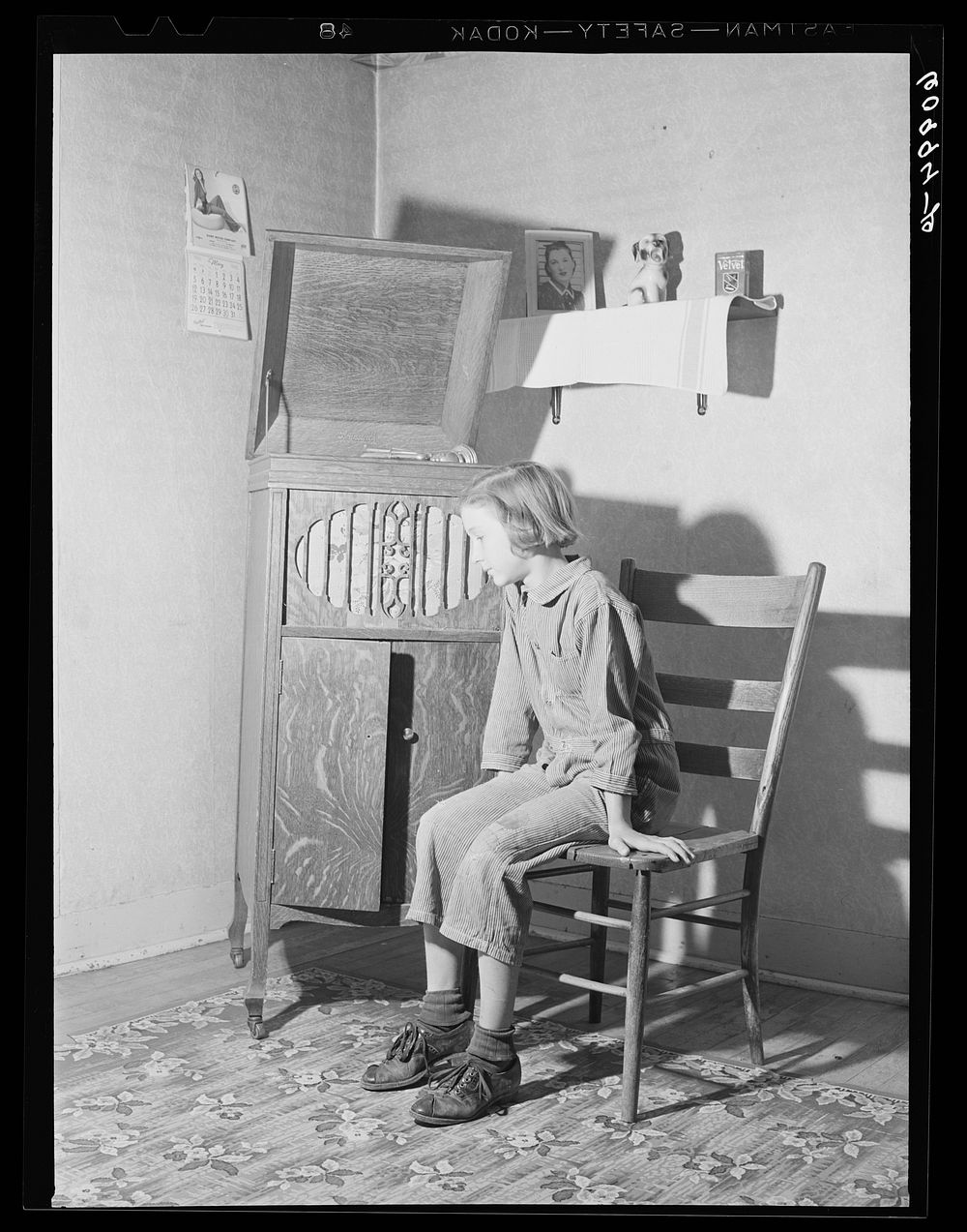 Daughter of FSA (Farm Security Administration) rehabilitation borrower listening to phonograph. Crawford County, Illinois.…