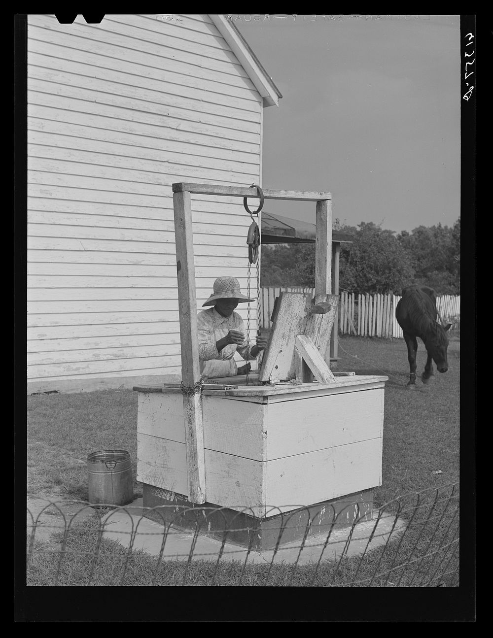 Aged FSA (Farm Security Administration) borrower drawing water from well. Saint Mary's County, Maryland. Sourced from the…