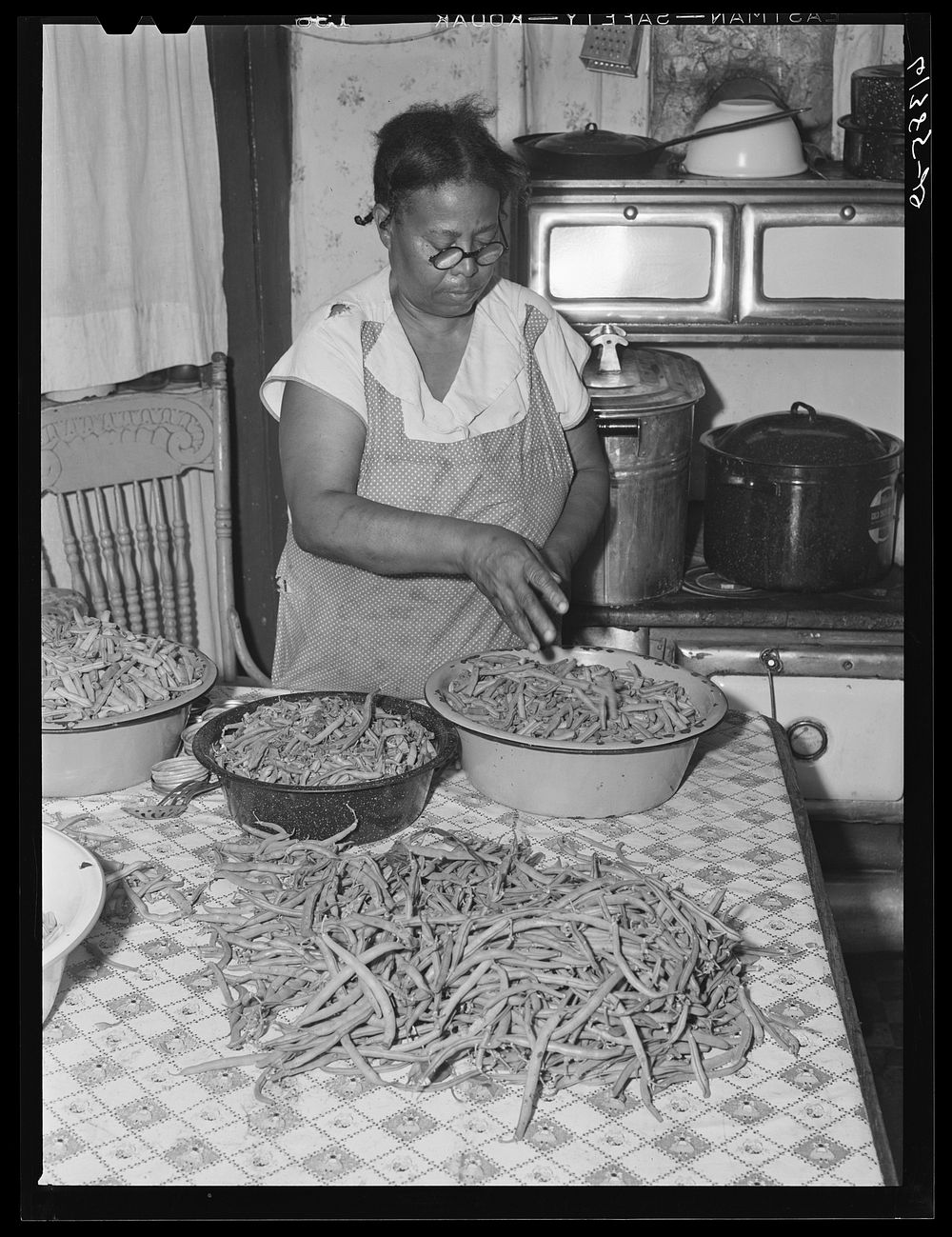 Mrs. Eugene Smith, FSA (Farm Security Administration) borrower, preparing string beans for cutting. Saint Mary's County…
