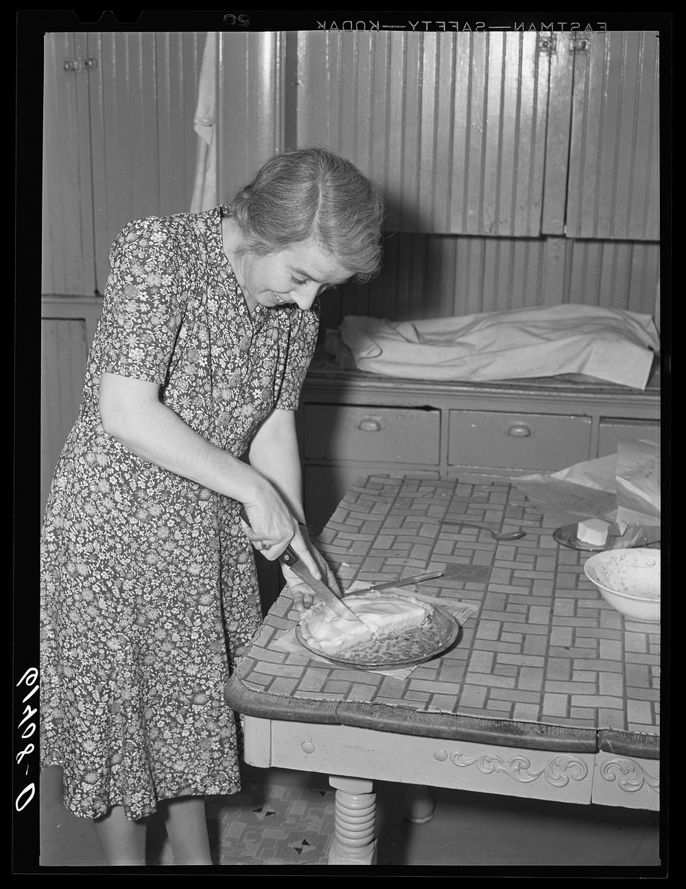 Farm woman cutting pieces of pie for supper. Meeker County, Minnesota. Sourced from the Library of Congress.