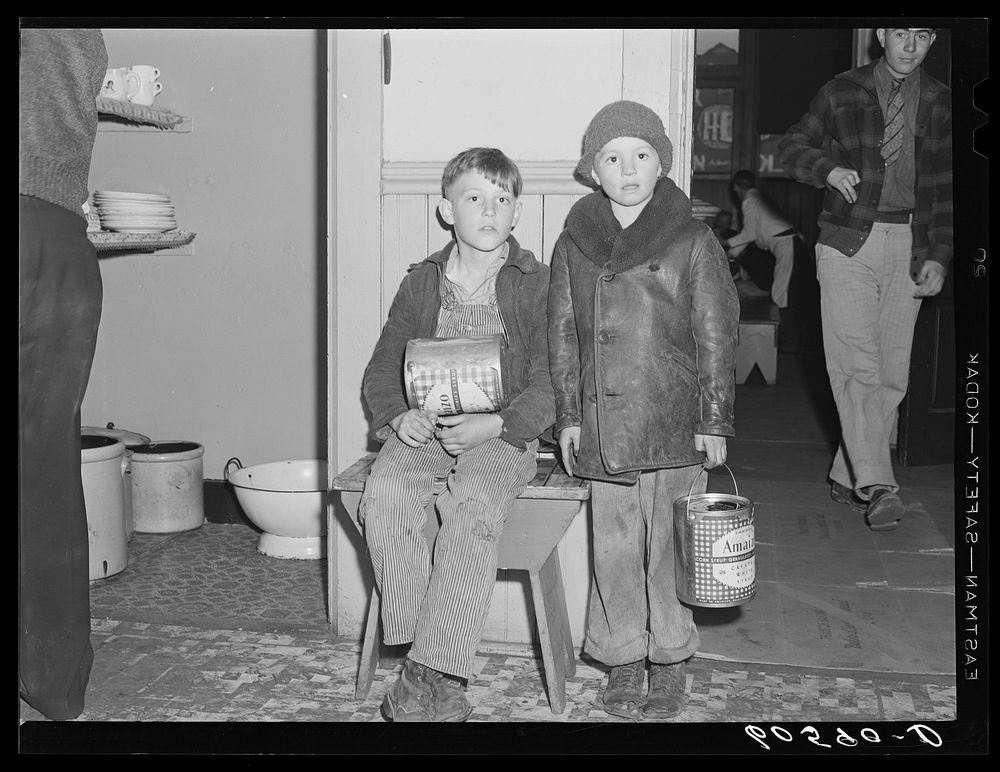 Young boys waiting in kitchen of city mission for soup which is given out nightly. Dubuque, Iowa. Sourced from the Library…