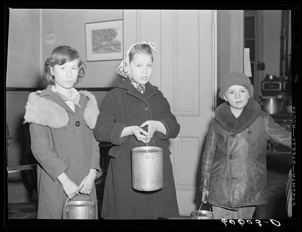 Children of poor families bring their pails to the city mission for soup which may be left over after twenty-five men have…