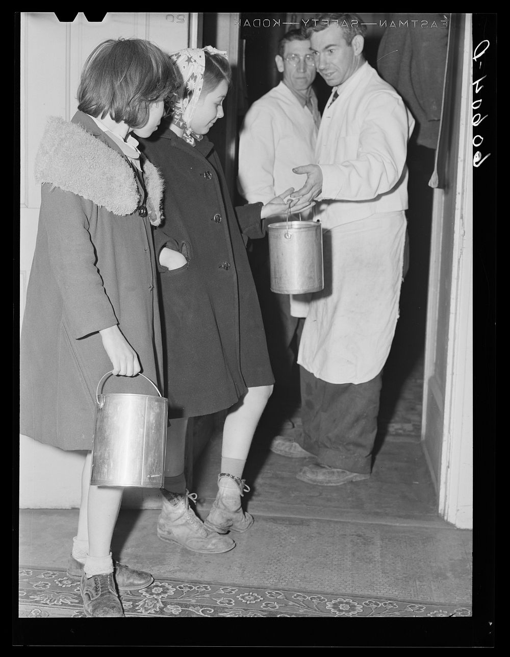 Child receiving pail of soup to bring home to her family. Children come to the city mission every evening after twenty-five…