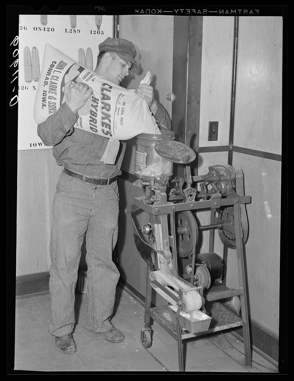 Machine for testing plates used in corn planter in office of hybrid seed corn plant. Conrad, Iowa. Sourced from the Library…