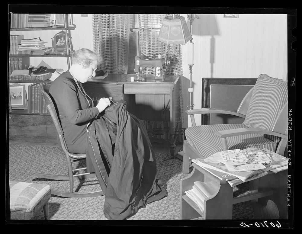 [Untitled photo, possibly related to: Wife of Iowa corn farmer sewing choir robes for Methodist church. Greene County…