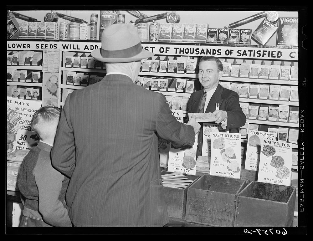 Making a sale. Seed store, Marshalltown, Iowa. Sourced from the Library of Congress.