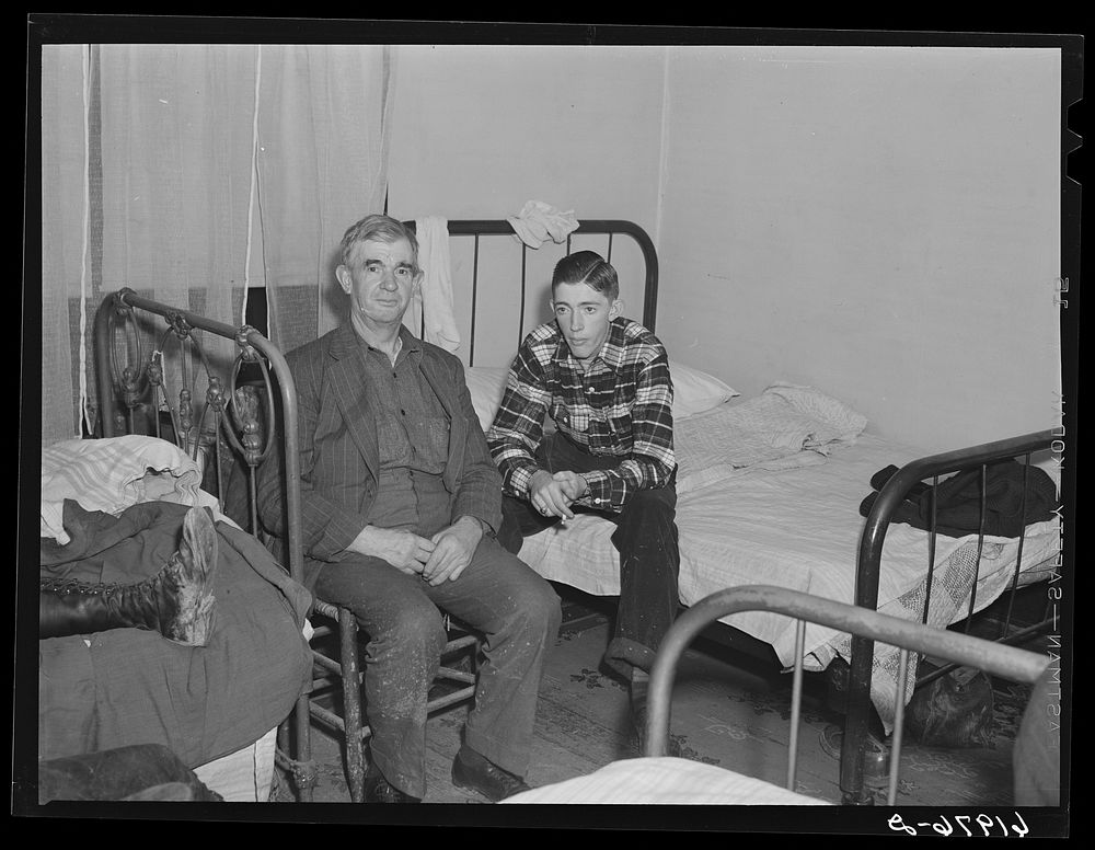 Father and son from Bluefield, West Virginia Both employed at powder plant. Radford, Virginia. In boardinghouse room which…