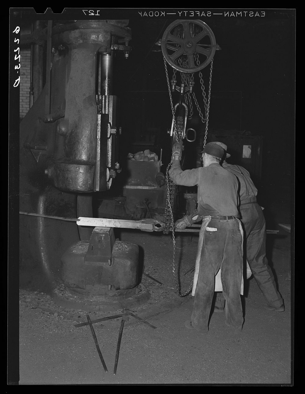 Using 2000 pound steam hammer on jar rein for drilling equipment. Keystone Drilling Company, Beaver Falls, Pennsylvania.…