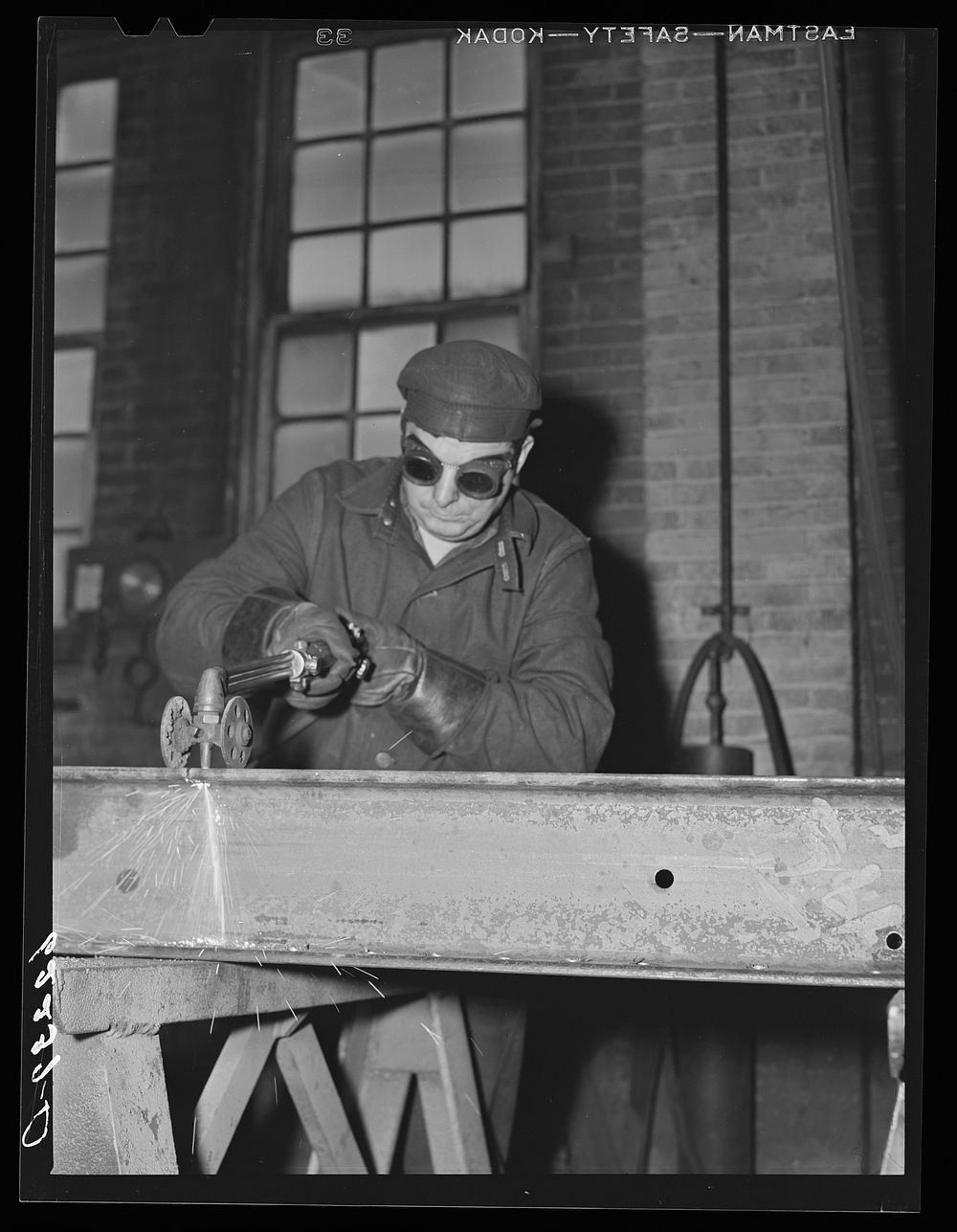Acetelyne torch cutting. Structural shop, Keystone Drilling Company. Beaver Falls, Pennsylvania. Sourced from the Library of…