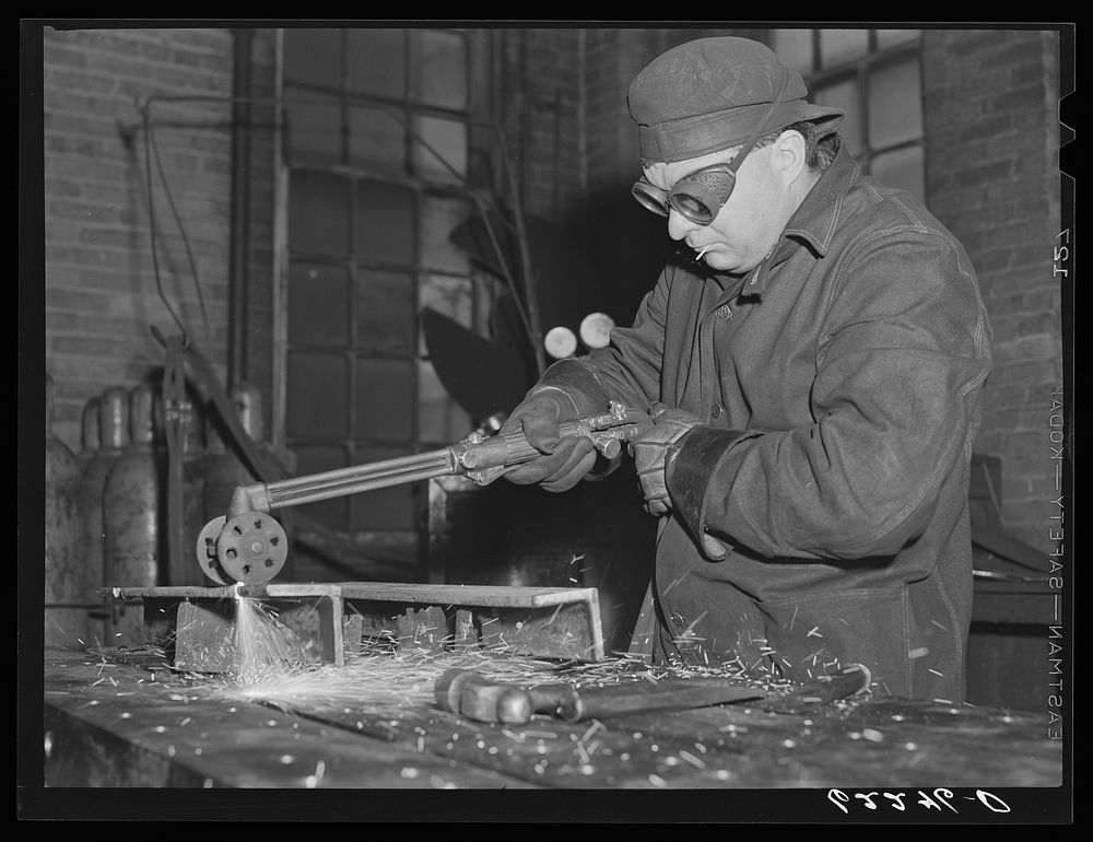 Acetelyne torch cutting, structural shop. Keystone Drilling Company, Beaver Falls, Pennsylvania. Sourced from the Library of…