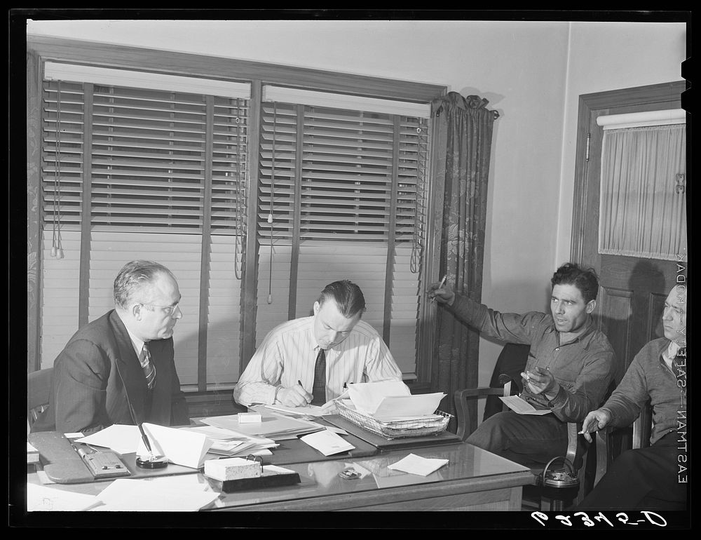 Subregional office, steelworkers organizing committee, Ambridge, Pennsylvania. Subregional director Joe Timko (left) listens…