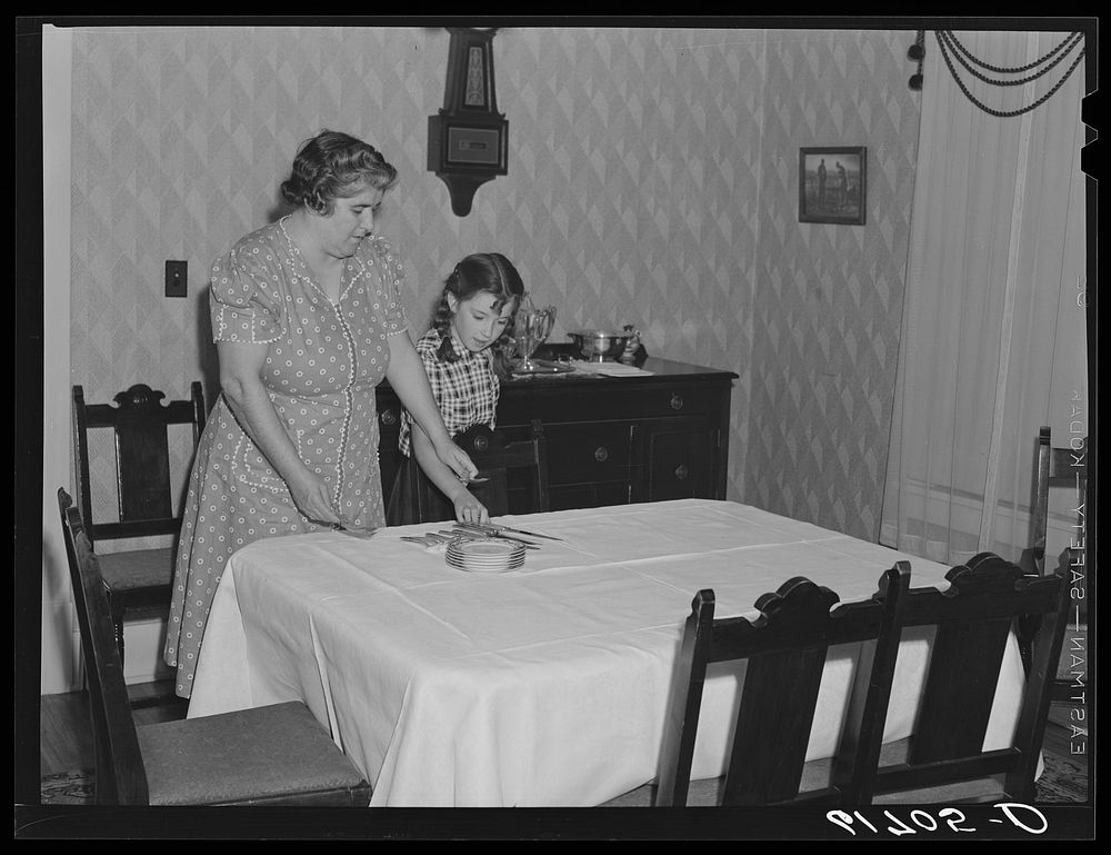 Mrs. Schulstad and daughter laying the table for dinner. Aberdeen, South Dakota. Sourced from the Library of Congress.
