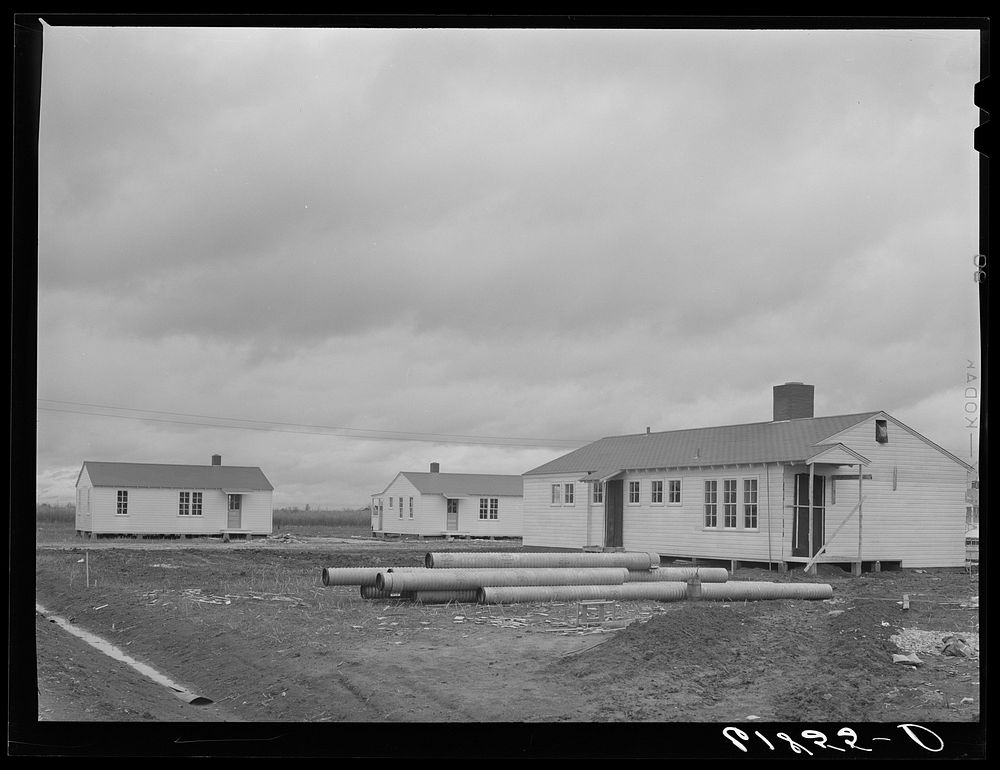 Utility building and some of the houses at Morehouse group of labor homes. New Madrid County, Missouri. Sourced from the…