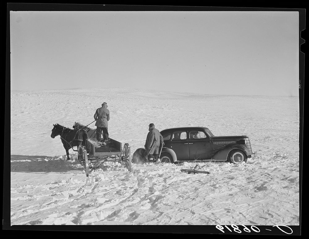 Pulling government car out of snow drift. Todd County, South Dakota. Sourced from the Library of Congress.