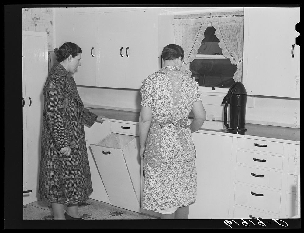 Home supervisor with wife of tenant purchase borrower in new kitchen. Labette County, Kansas. Sourced from the Library of…