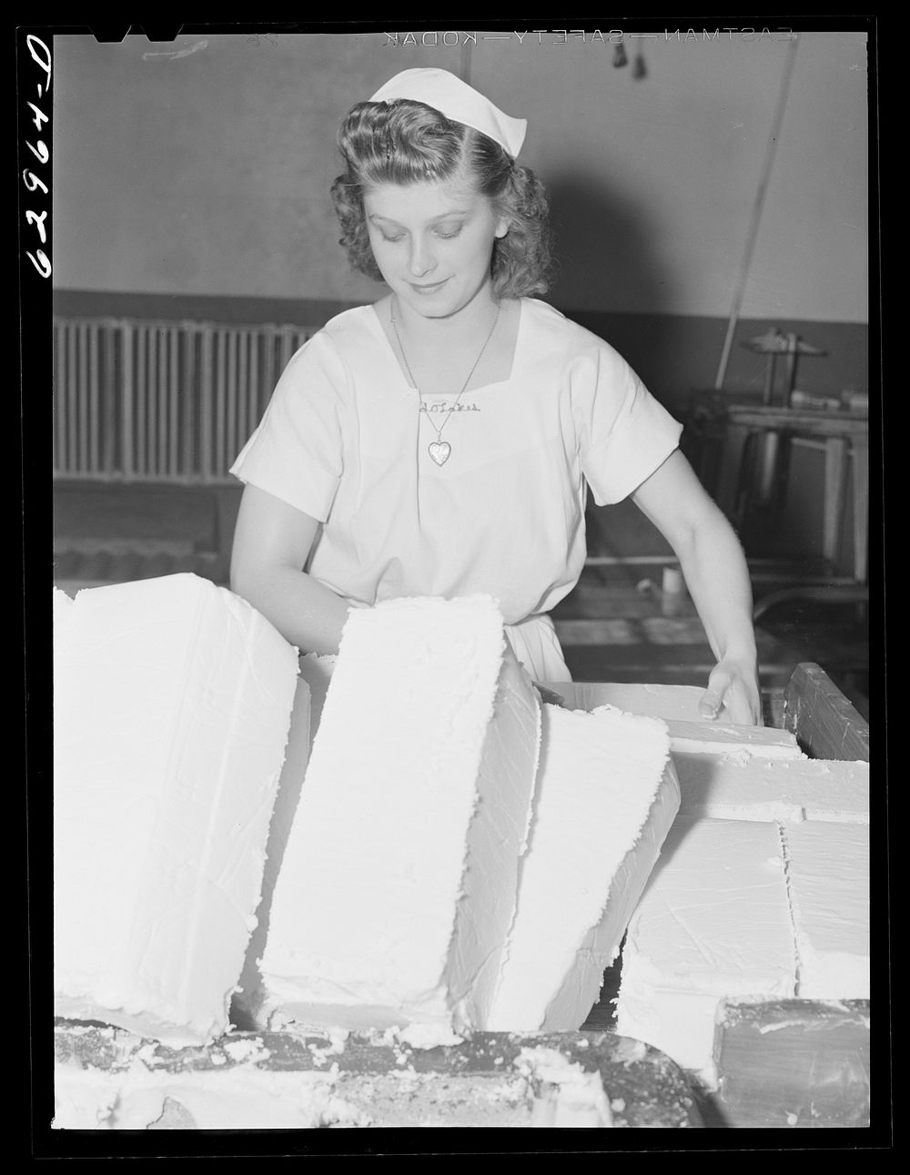 Preparing butter for cutting and packing. Land O'Lakes plant, Chicago, Illinois. Sourced from the Library of Congress.
