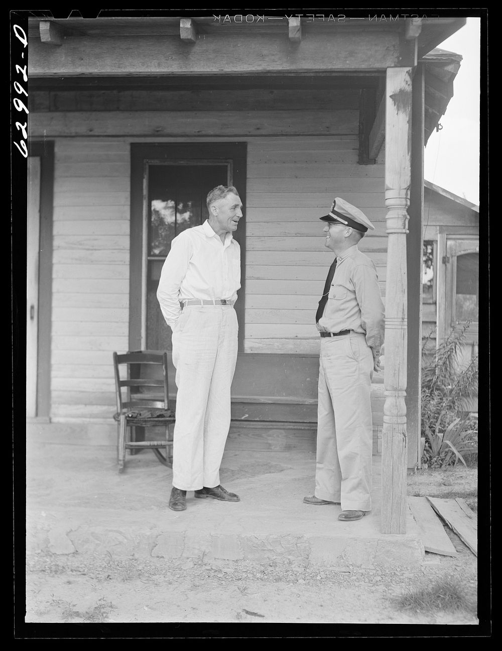 Lieutenant Sedgewick of United States Navy talking with Luther Corbin, a farmer whose land has been bought by Navy for…