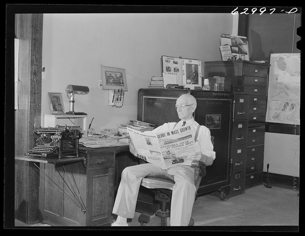 John W. Dillard, real estate and insurance man, and member of local Townsend Club, in his office at Washington, Indiana.…