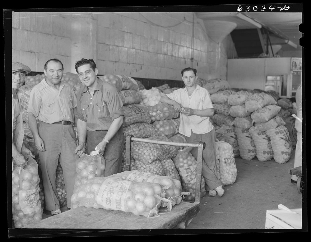 Onions and potatoes at produce market, where commission merchants sell to retailers. Chicago, Illinois. Sourced from the…