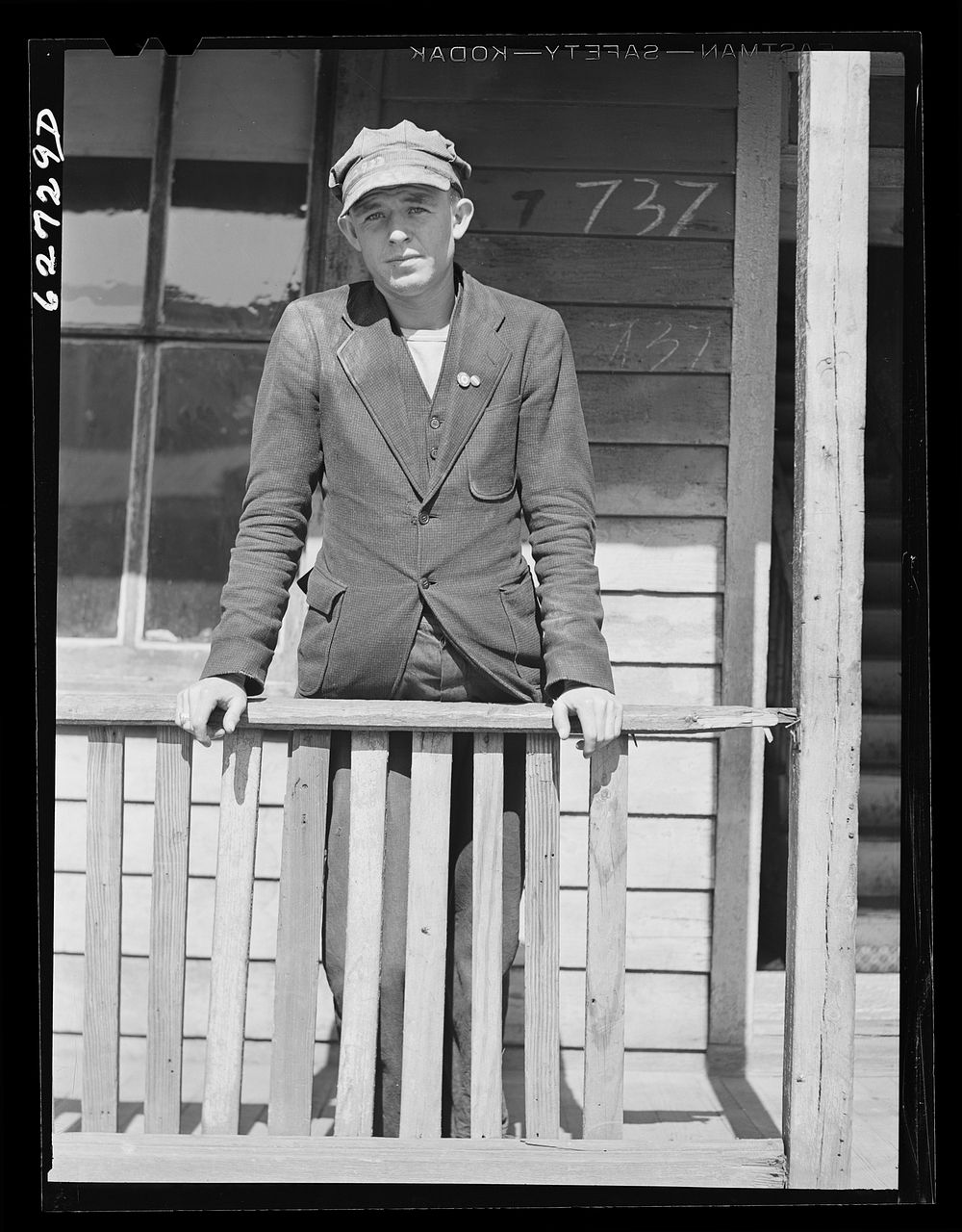 Navy yard worker on porch of rooming house. Portsmouth, Virginia. Sourced from the Library of Congress.
