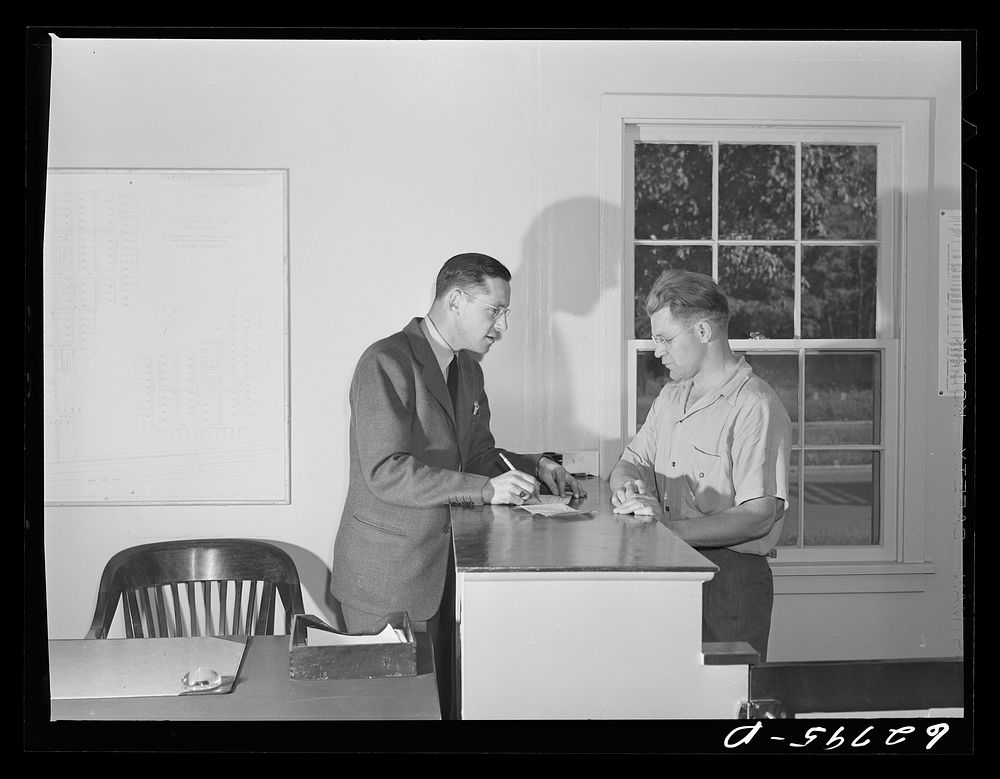General Electric employee applying for trailer at FSA (Farm Security Administration) camp office. Milton Ackerman, camp…