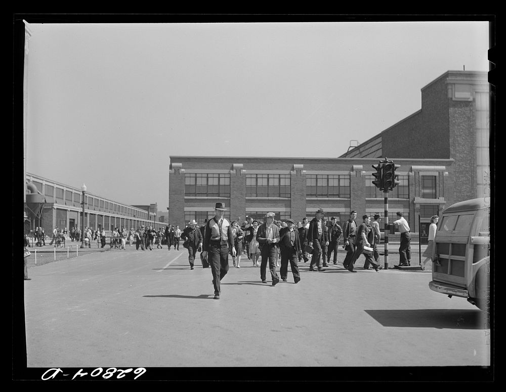 General Electric workers leaving the plant at 4:00 p.m. Another shift comes on immediately; they are running twenty-four…