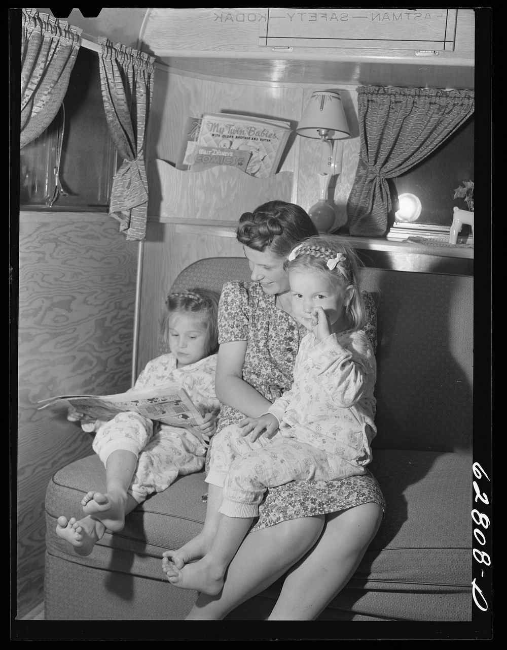 Mrs. Jack Cutter and two children in their trailer at FSA (Farm Security Administration) camp, Erie, Pennsylvania. Her…