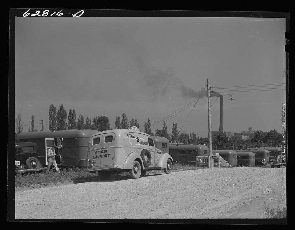 Laundry wagon calling at trailer in FSA (Farm Security Administration) camp, Erie, Pennsylvania. There are no stores or…