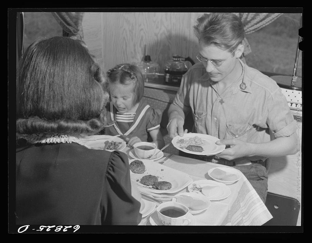 Jack Cutter and family at dinner. FSA (Farm Security Administration) trailer camp. Erie, Pennsylvania. Sourced from the…