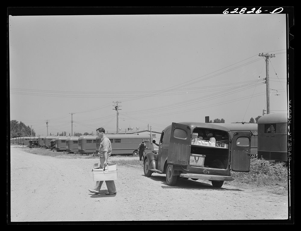 Grocery truck making delivery to trailer. FSA (Farm Security Administration) camp, Erie, Pennsylvania. There are no stores…