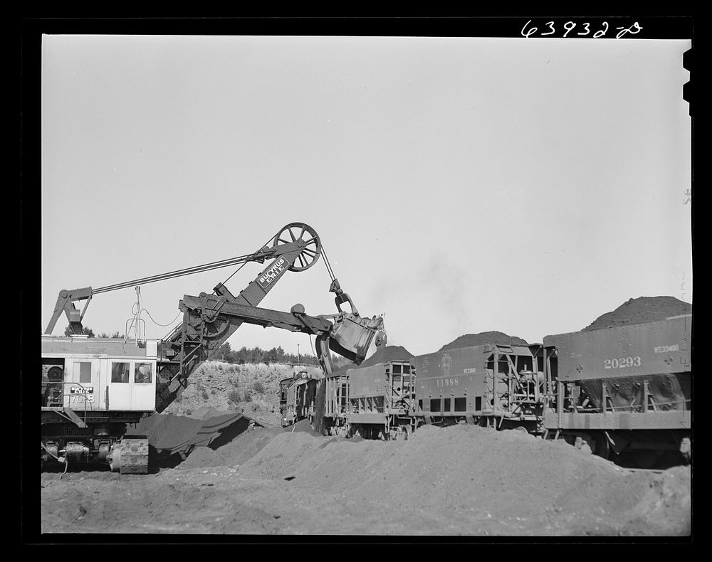 [Untitled photo, possibly related to: Electric shovel loading iron ore into railroad cars, eight cubic yards per shovelful.…