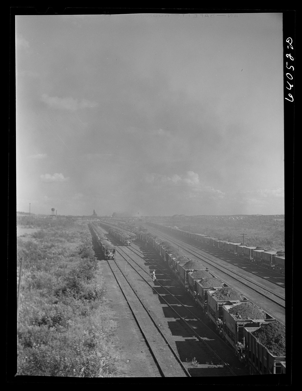 Seventy ton cars of iron ore in D.M. & I.R. railroad yards on way to Duluth ore docks. Sourced from the Library of Congress.