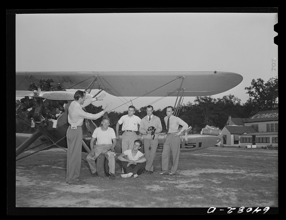 [Untitled photo, possibly related to: Instructor with group of student flyers under Civilian Pilot Training Program.…