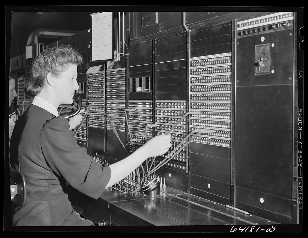 Telephone operator at Aberdeen proving grounds. She lives in dormitory for defense workers. Aberdeen, Maryland. Sourced from…