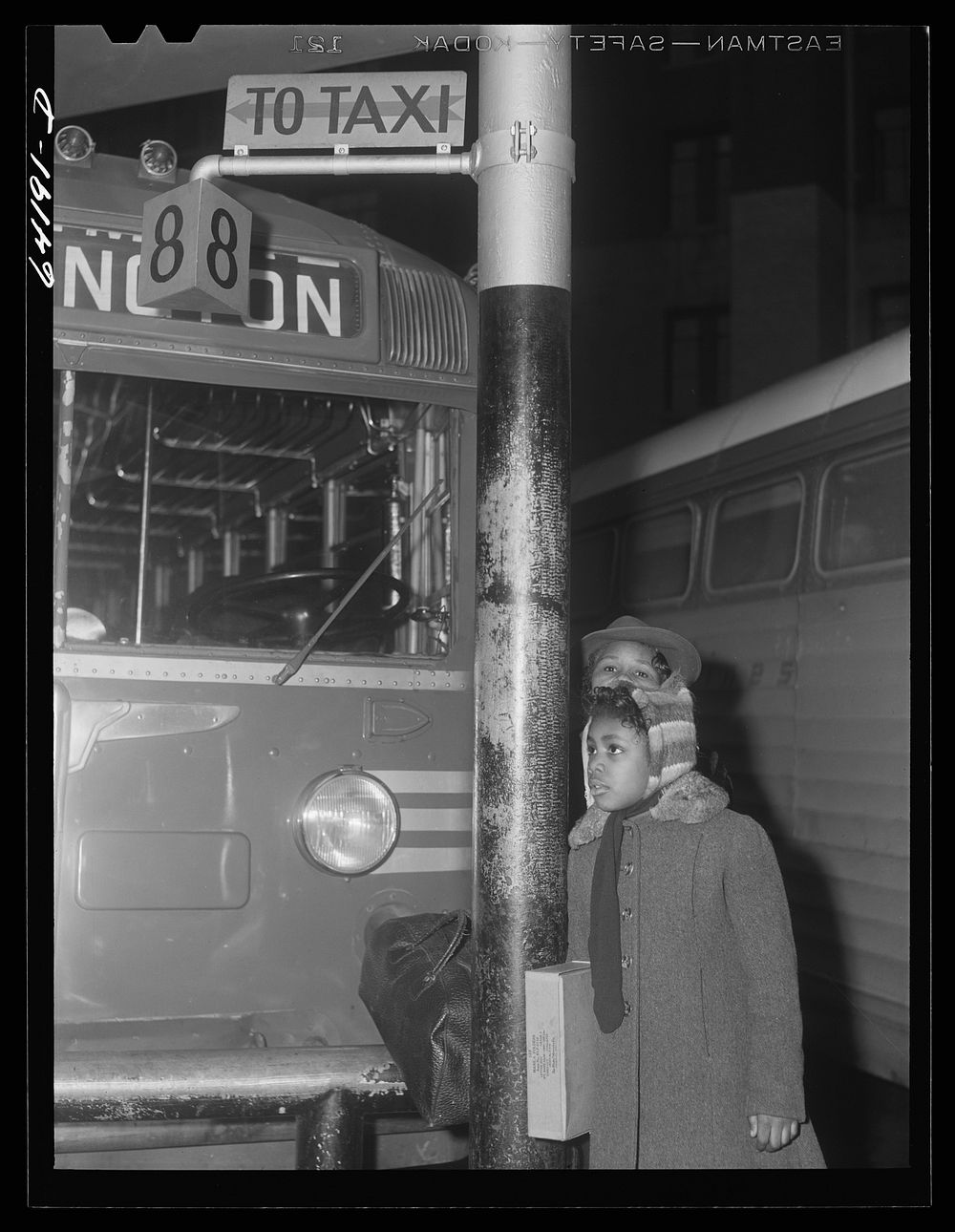 Washington, D.C. Greyhound bus terminal on the day before Christmas. Little girl waiting. Sourced from the Library of…