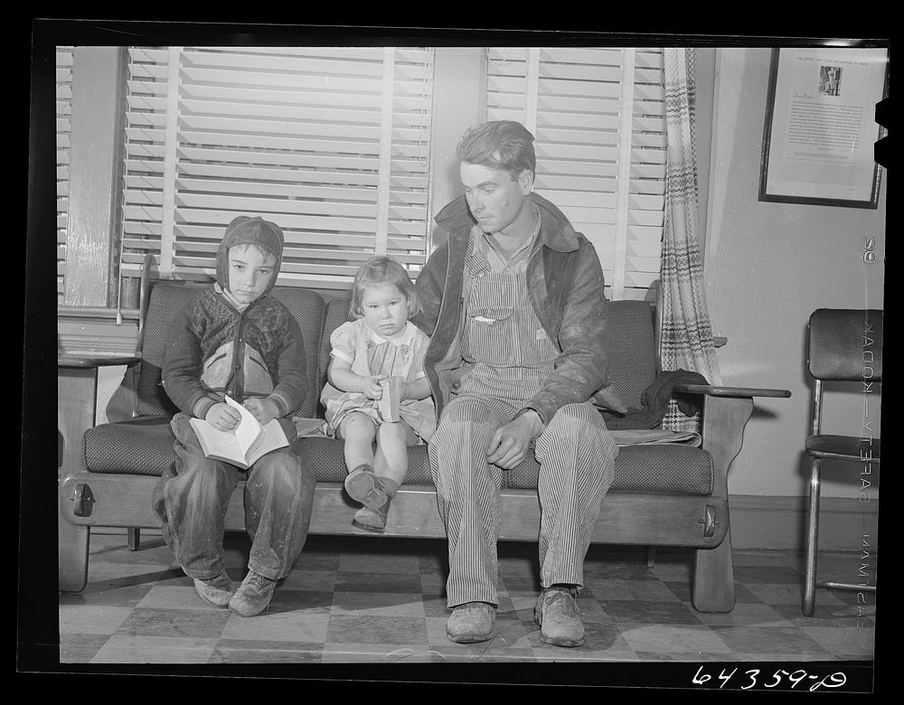 Chafee, Missouri. Father and children waiting to see the doctor. The little girl was bitten by a dog and is to receive anti…