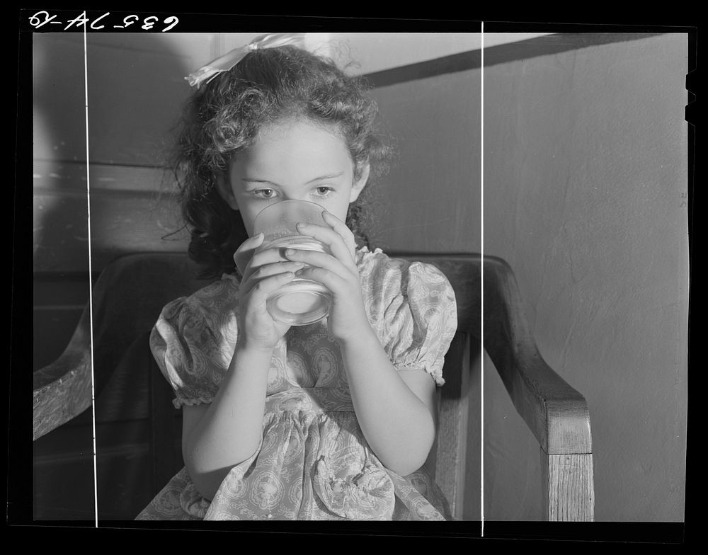 Child drinking milk. Duluth, Minnesota. Sourced from the Library of Congress.